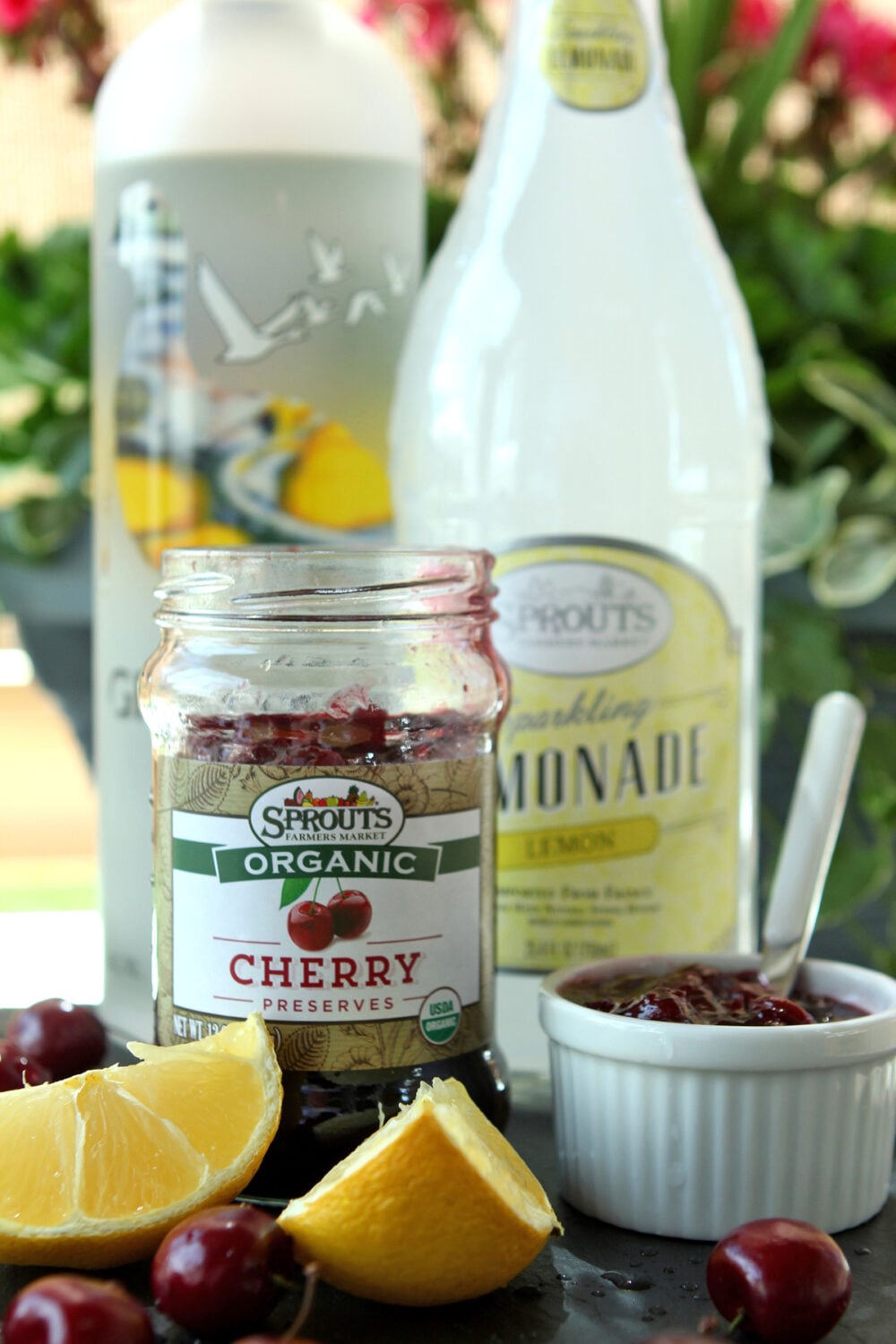 Ingredients for a Cherry Lemonade Vodka Spritzer including a bottle of vodka, another one of lemonade.