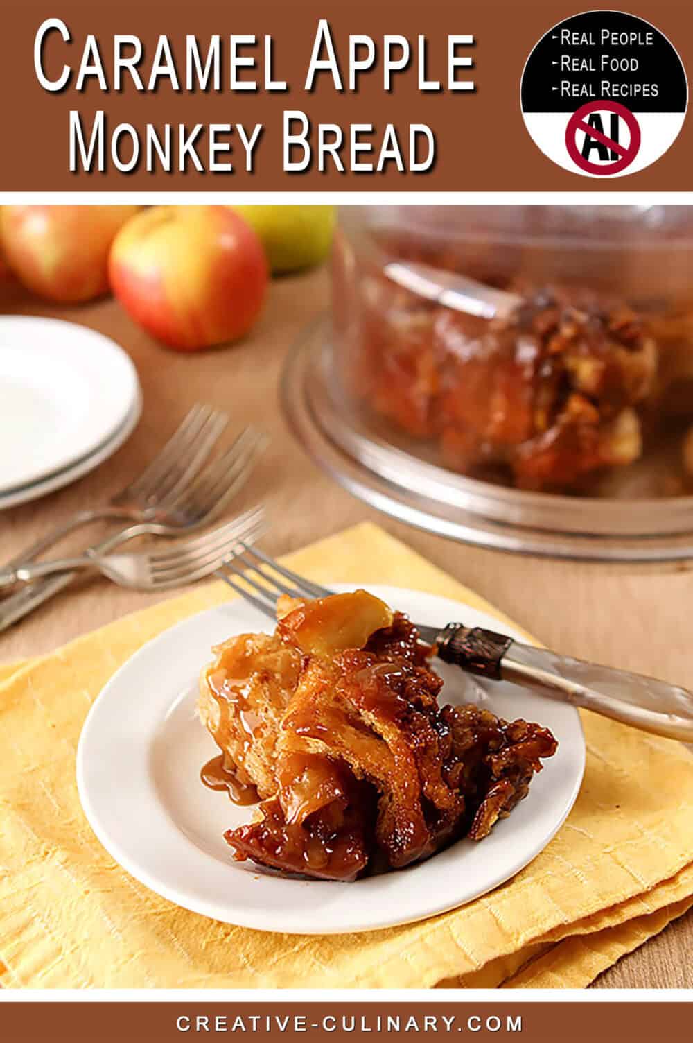 Close-up of caramel apple monkey bread on a white plate with apples in background.
