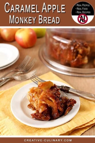 Close-up of caramel apple monkey bread on a white plate with apples in background.