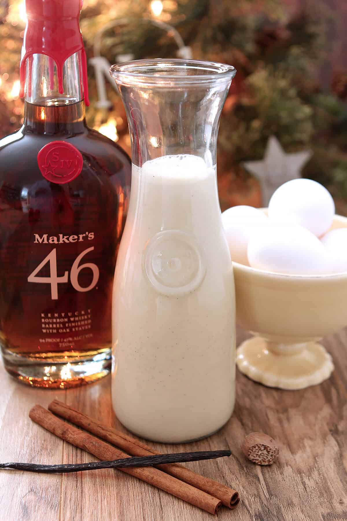 Homemade eggnog with Maker's Mark Bourbon in a tall glass pitcher for serving.