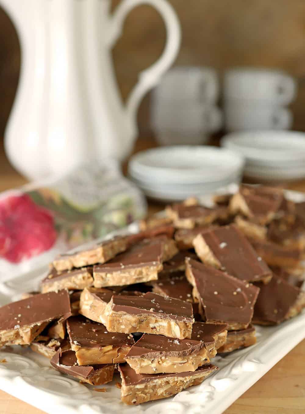 English Toffee with Salted Chocolate and Toasted Almonds on a White Serving plate.