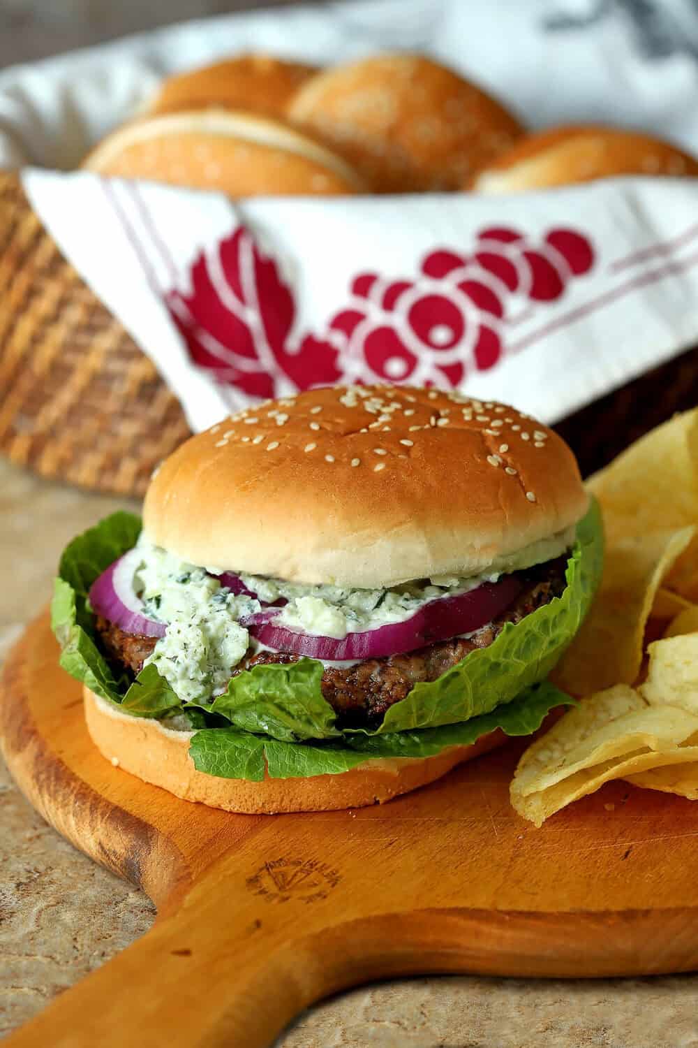 Vegetarian Greek veggie burger with lettuce, onion, and feta cheese on a bun.