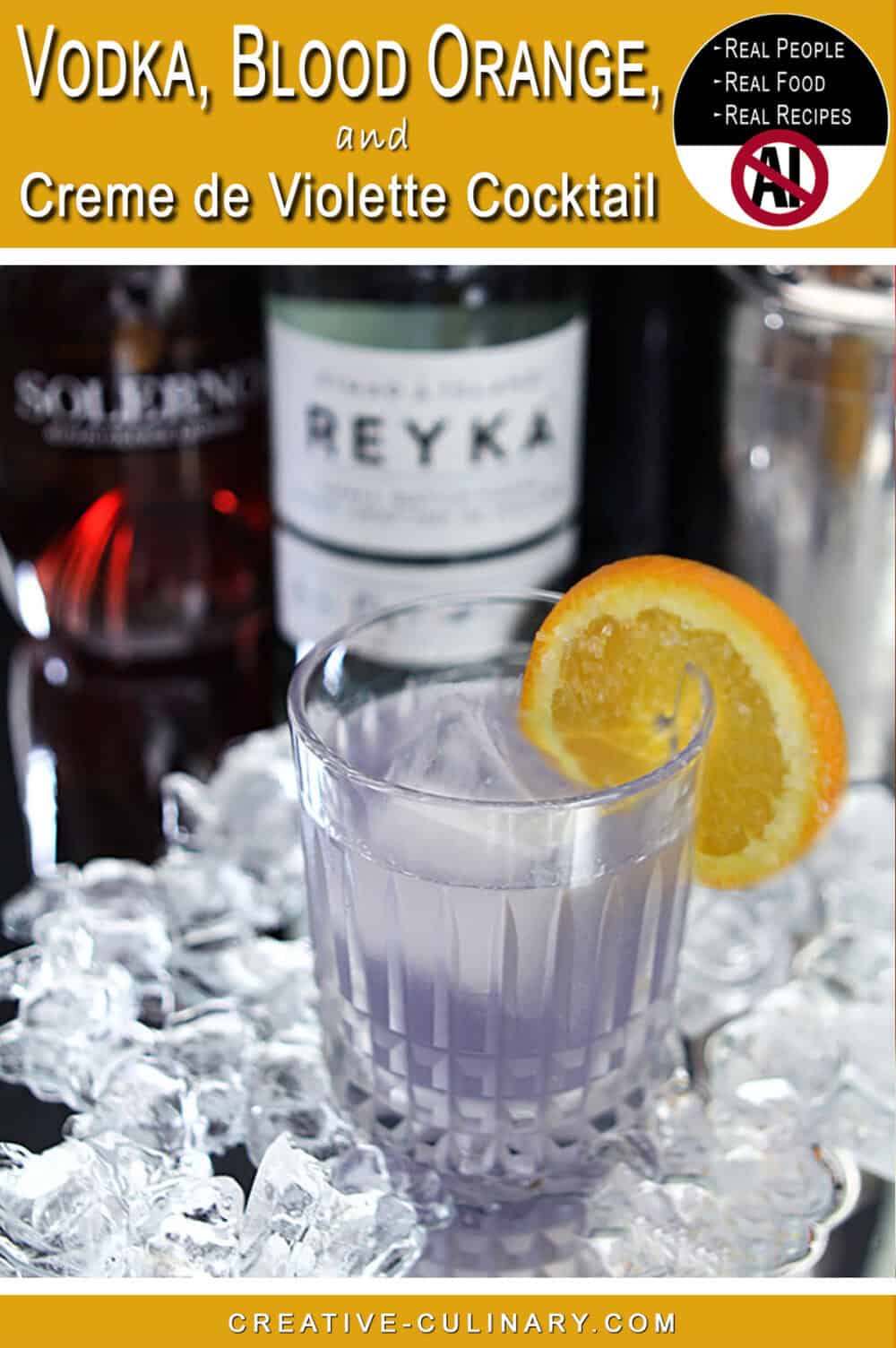 Elegant cocktail with violet hue garnished with orange slice on ice.