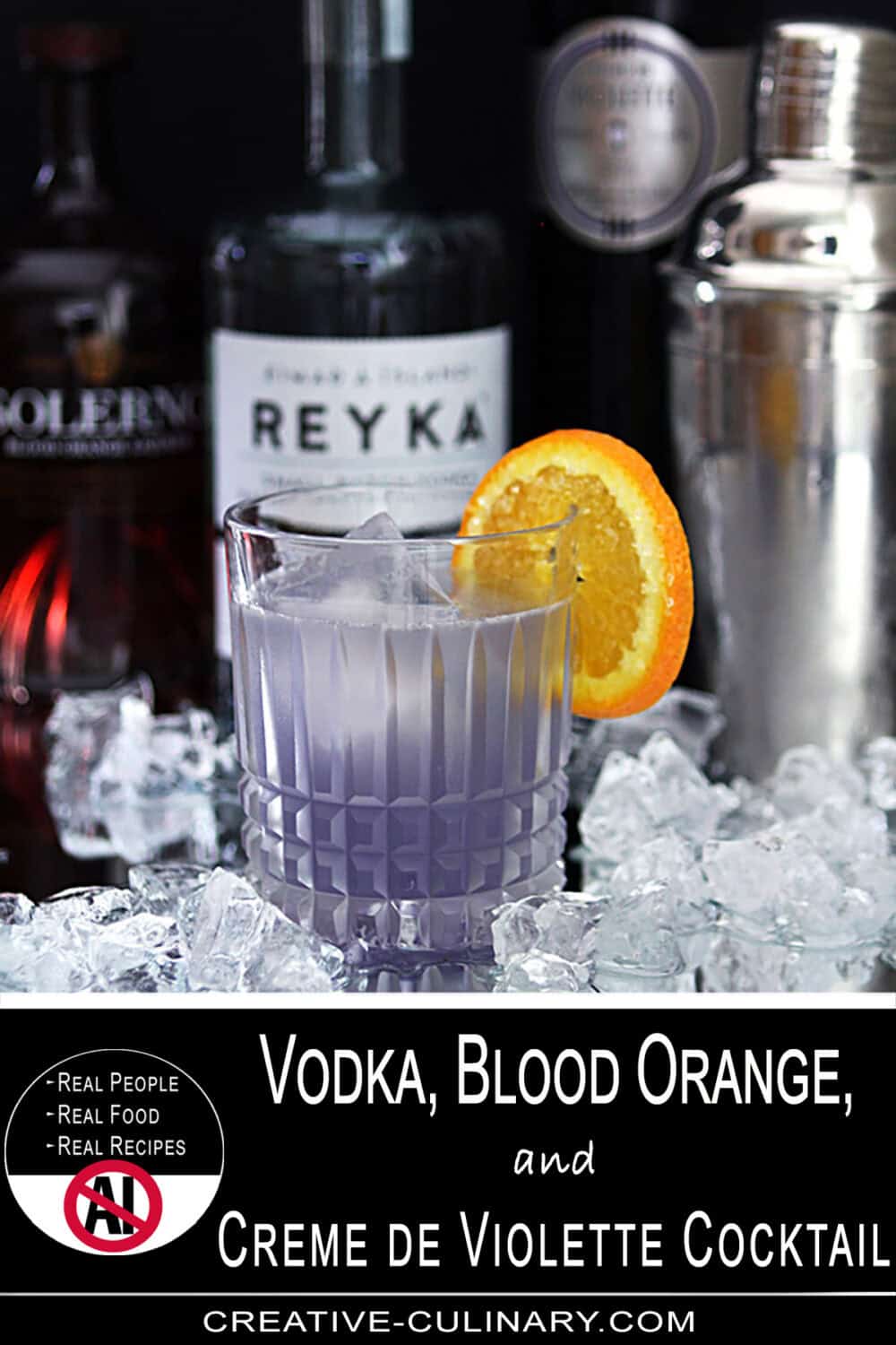 Vibrant cocktail with blood orange slice and purple hue in a glass.